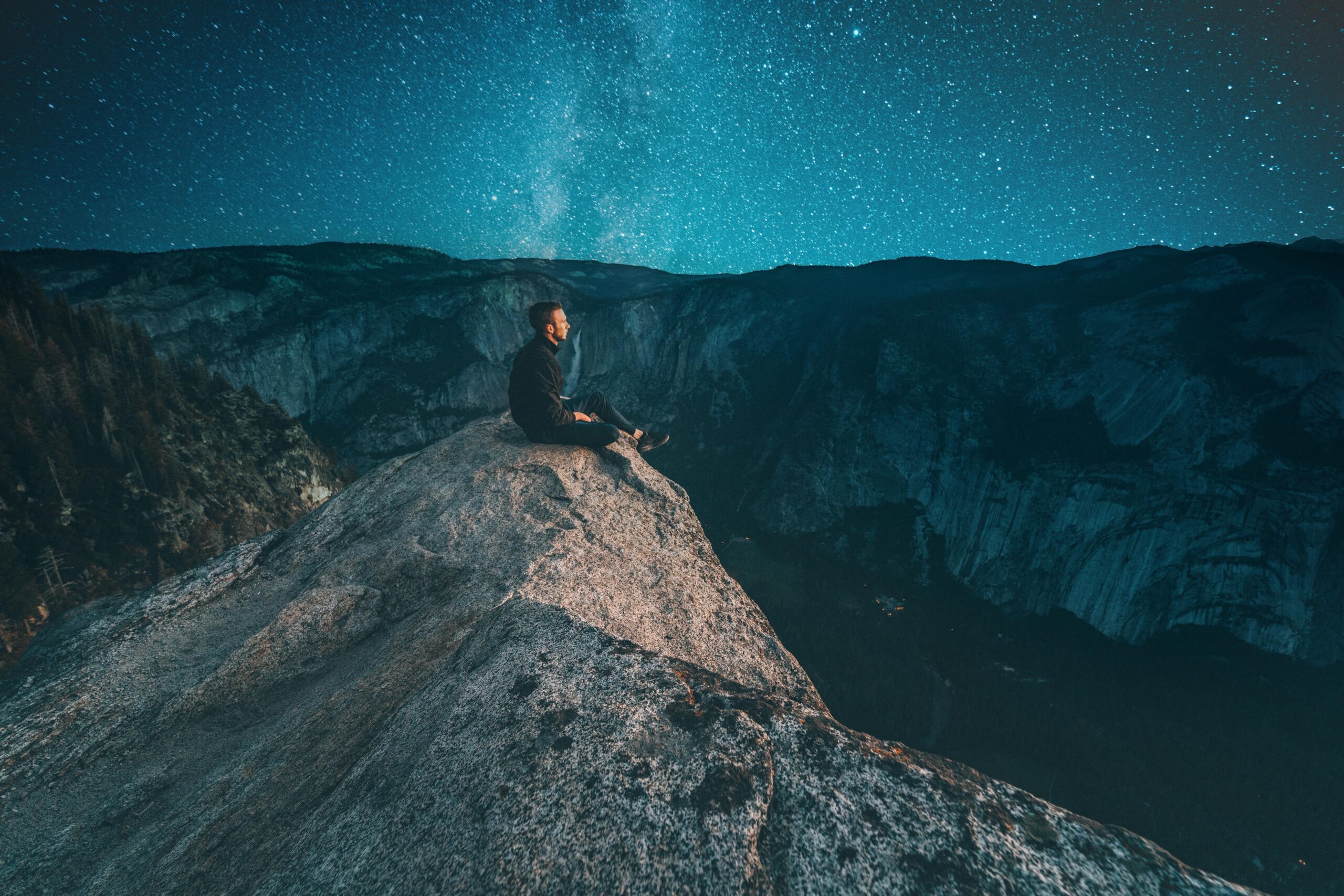 person sitting on mountain